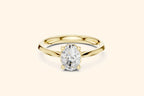 A classic solitaire engagement ring featuring an oval-cut diamond held by six prongs on a polished yellow gold band.