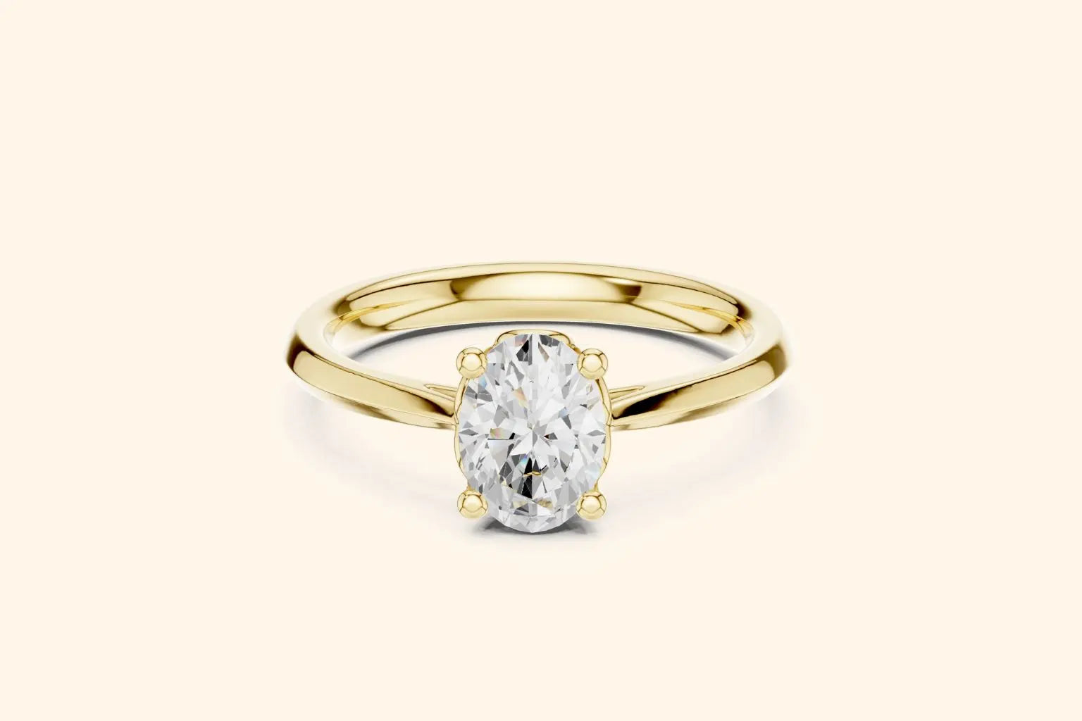 A classic solitaire engagement ring featuring an oval-cut diamond held by six prongs on a polished yellow gold band.