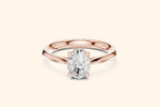 A classic solitaire engagement ring featuring an oval-cut diamond held by six prongs on a polished rose gold band.