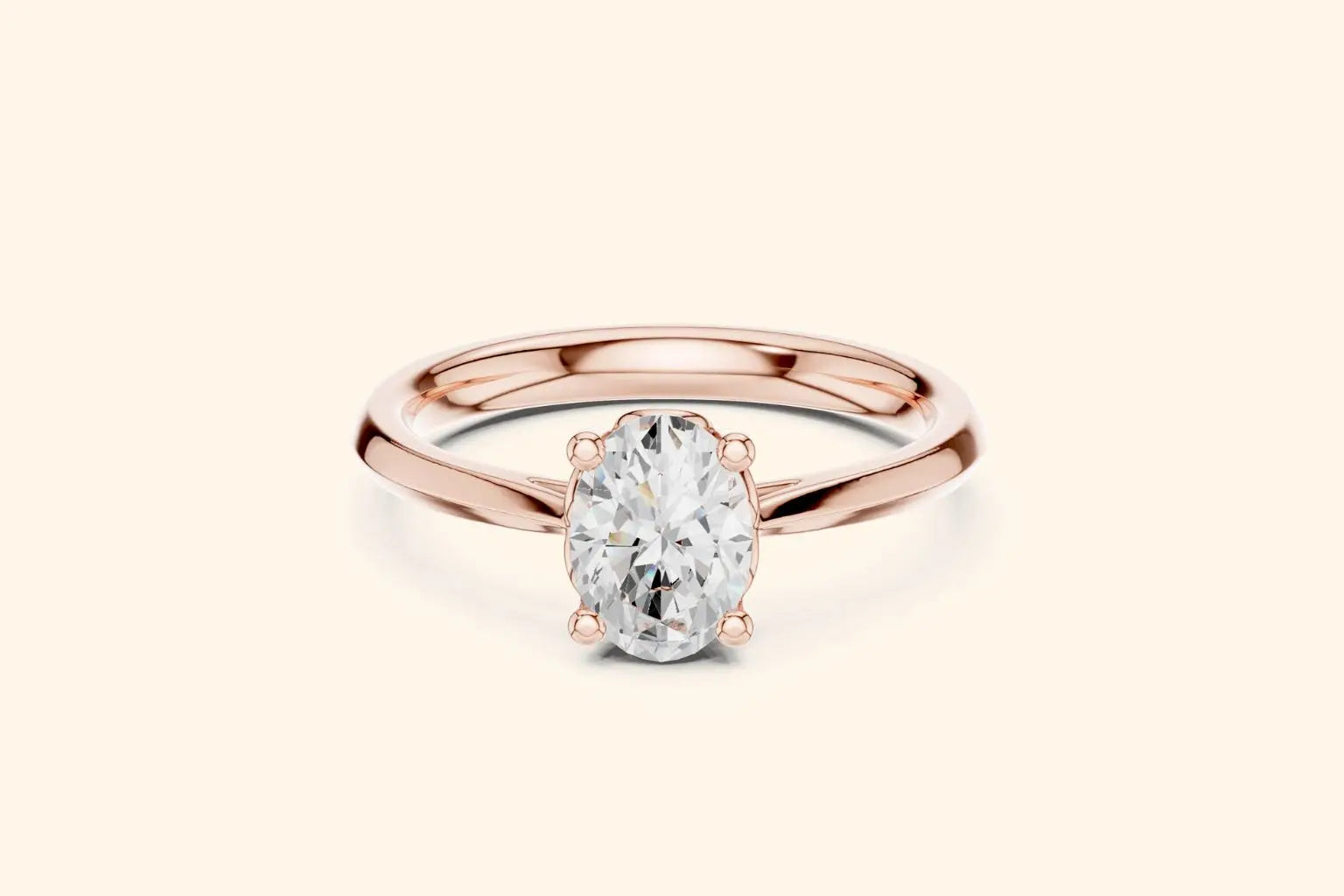 A classic solitaire engagement ring featuring an oval-cut diamond held by six prongs on a polished rose gold band.
