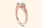 Side view of a rose gold solitaire ring, showcasing the open split-shank band and the ornate basket setting holding a round or cushion diamond.