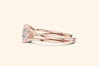 Side profile view of a rose gold engagement ring, showing the low-profile setting, the ornate gallery, and the smooth, split-shank band.