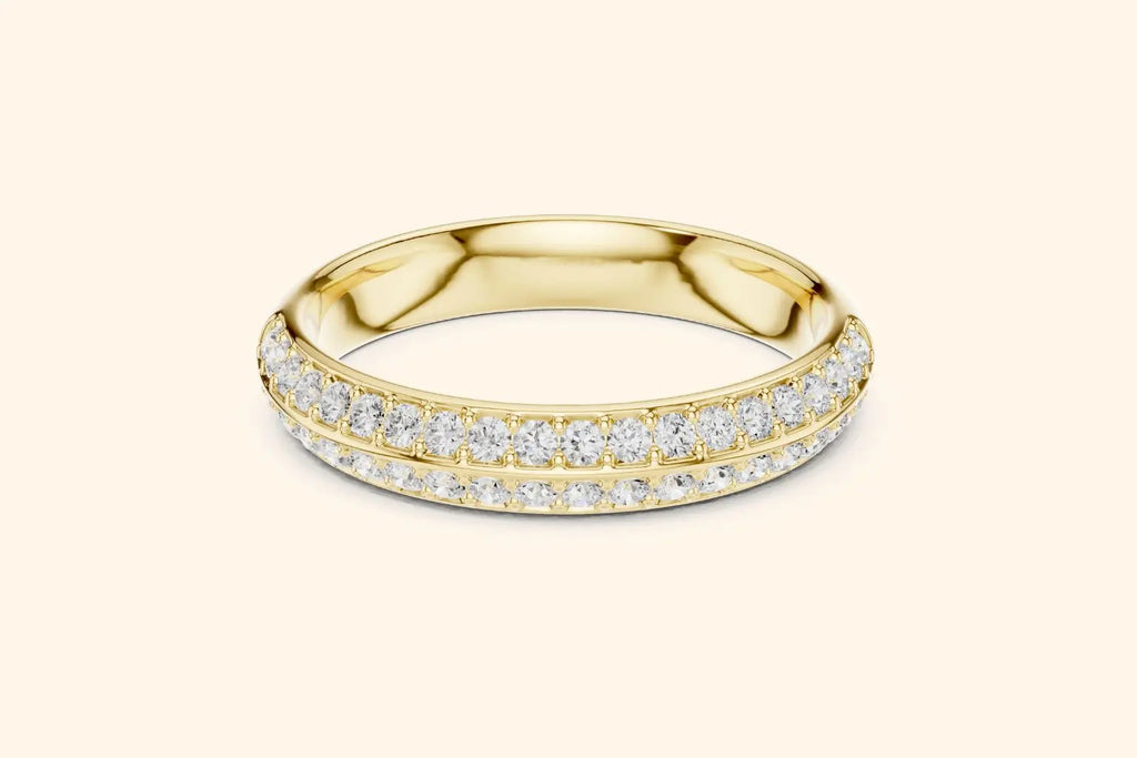 A brilliant pure gold eternity band ring featuring two continuous rows of round brilliant diamonds set in a pave style. The gold band is highly polished, providing a rich contrast to the dazzling, closely-set diamonds that encircle the ring.