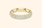 A brilliant pure gold eternity band ring featuring two continuous rows of round brilliant diamonds set in a pave style. The gold band is highly polished, providing a rich contrast to the dazzling, closely-set diamonds that encircle the ring.