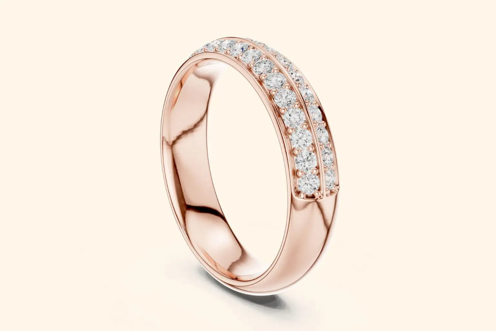 A slightly thick, high-polished rose gold band ring shown at an angle. The outer surface is adorned with two continuous rows of brilliant round diamonds set in a pave style, covering approximately half the circumference.