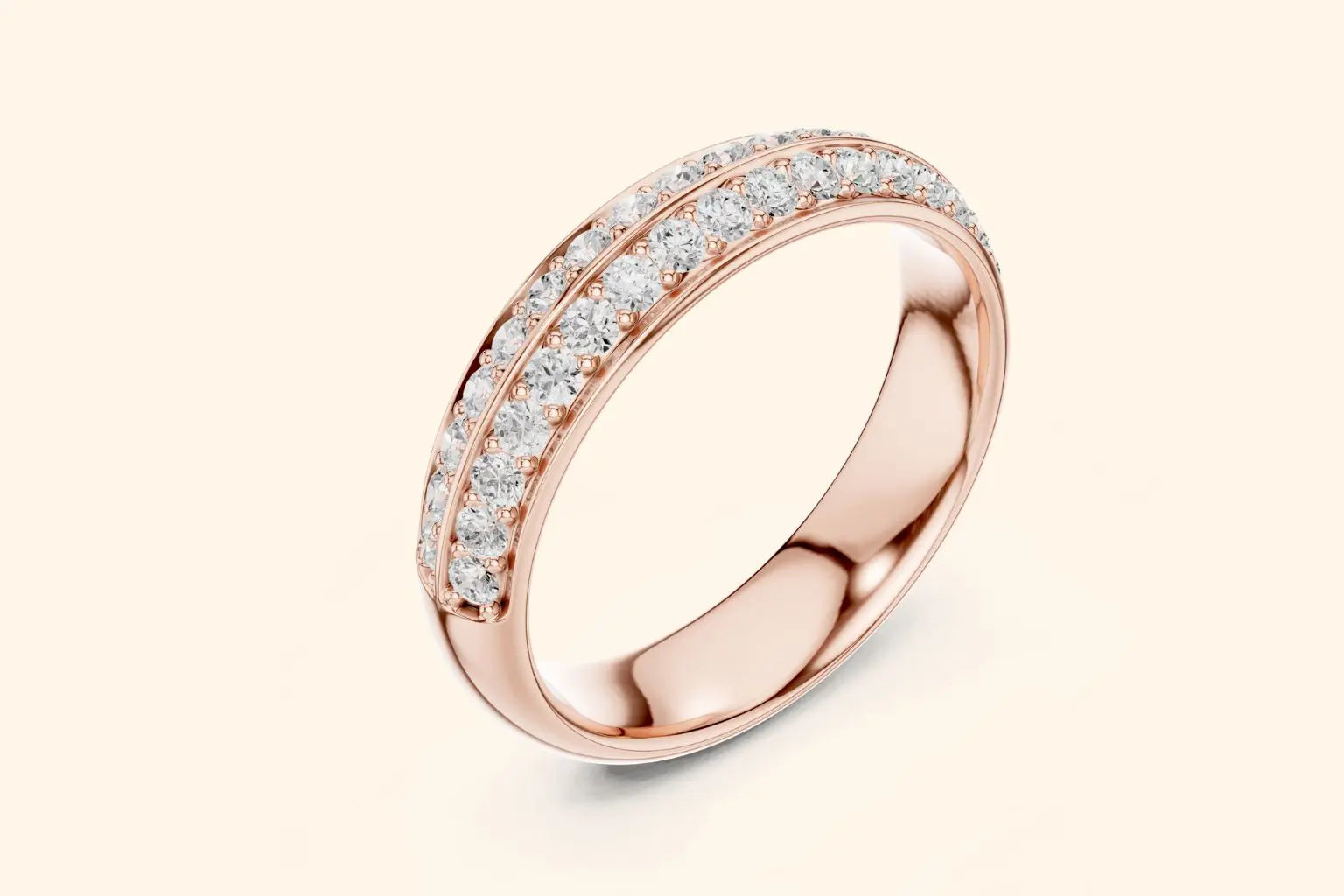 A sparkling rose gold band ring shown at a downward angle, with two parallel rows of pave-set round brilliant diamonds completely encircling the visible portion of the ring. The band has a smooth, rounded edge and a highly reflective surface.