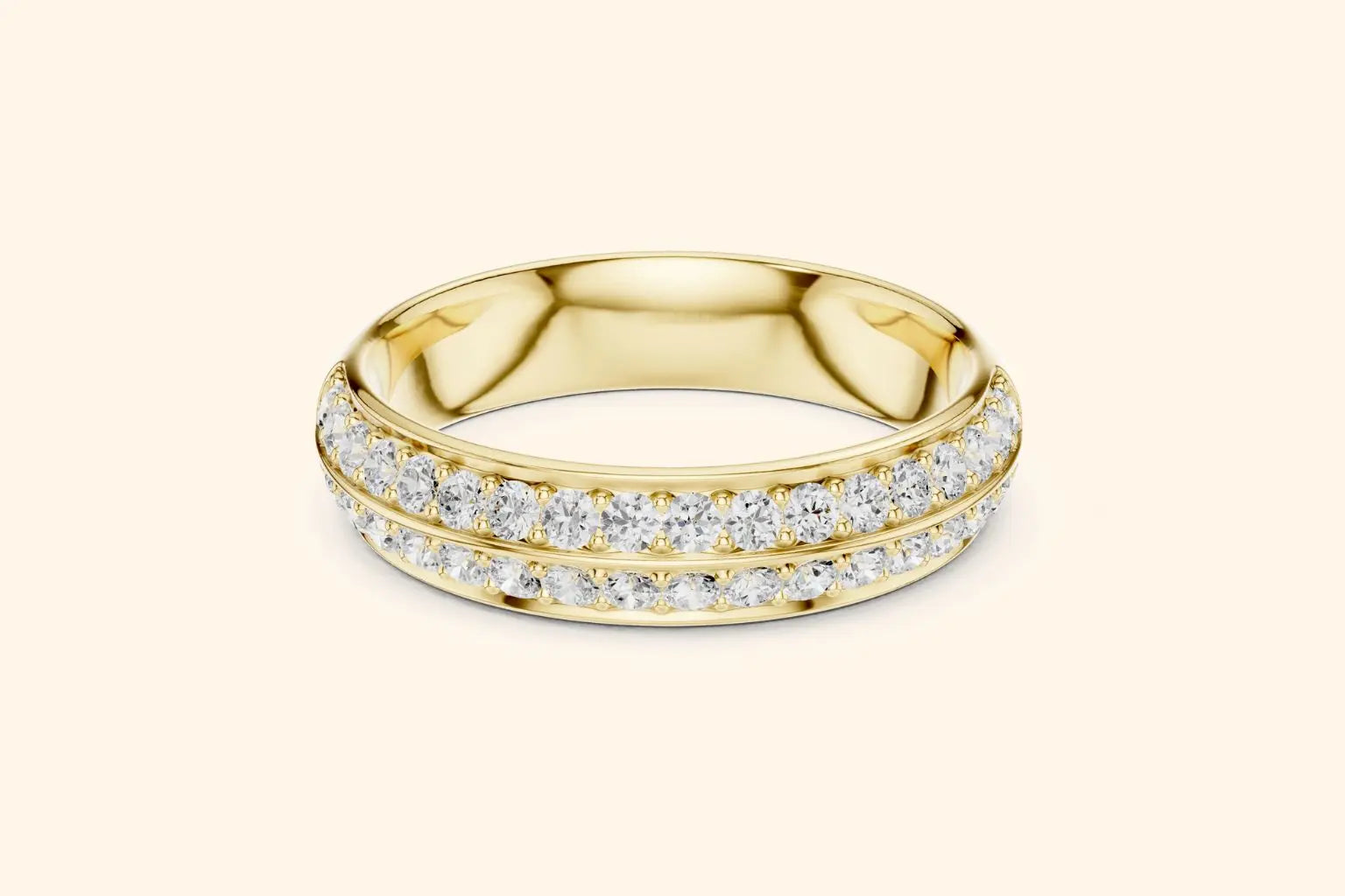A broad, highly reflective gold band ring featuring two continuous, closely-set rows of round brilliant diamonds in a pave setting. The bright gold metal provides a rich, warm frame for the dazzling sparkle of the diamonds.