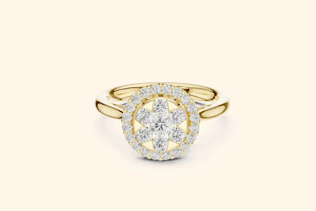 A rich pure gold ring with a prominent diamond setting. The centerpiece is an oval cluster of round brilliant diamonds arranged to resemble a large bloom or star, which is encircled by a dazzling pave-set diamond halo. The band is polished and sleek.