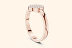 A steep, high-angled side-profile view of a delicate rose gold ring. The thin band leads up to the elevated, flat, round setting that is paved entirely with diamonds.