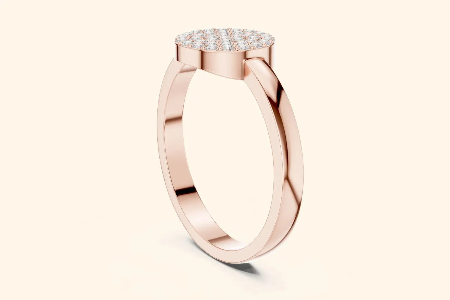 A steep, high-angled side-profile view of a delicate rose gold ring. The thin band leads up to the elevated, flat, round setting that is paved entirely with diamonds.