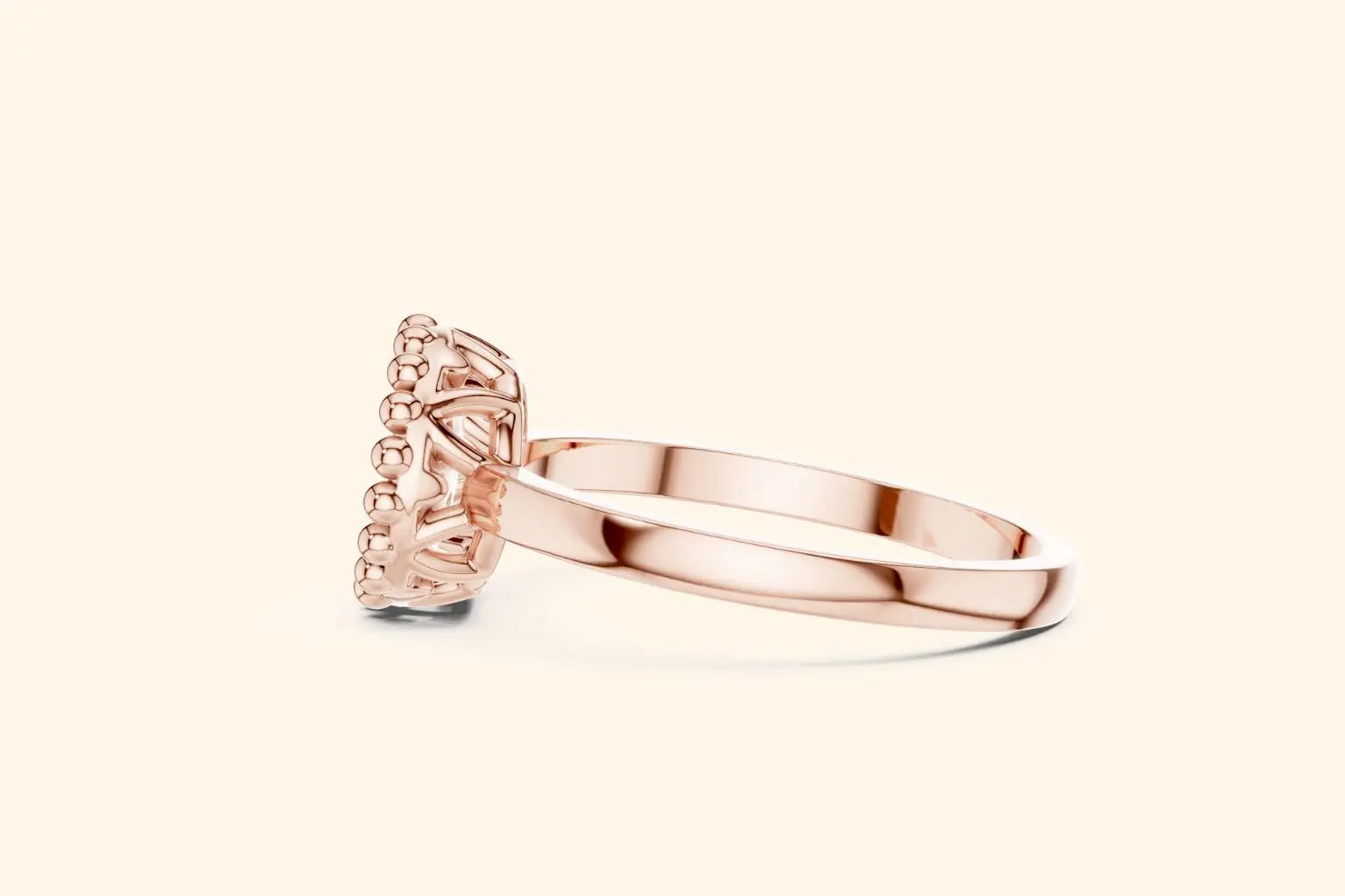 A side-profile view of a slender rose gold ring. The shot highlights the open, intricate basket setting beneath the round diamond cluster and beaded halo edge.