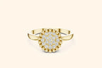 A front view of a stylish ring in bright gold or yellow gold. It showcases a round setting fully paved with diamonds, bordered by a pronounced beaded edge for texture and detail.