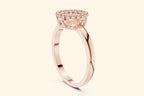 A side-profile view of a delicate rose gold ring showing the high-set, round head. The setting features a diamond cluster framed by a beaded halo on a slender, polished band.