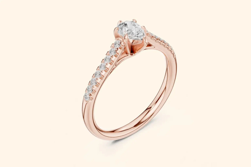 Angled profile view of a rose gold engagement ring showcasing the oval center diamond set above the pave band.