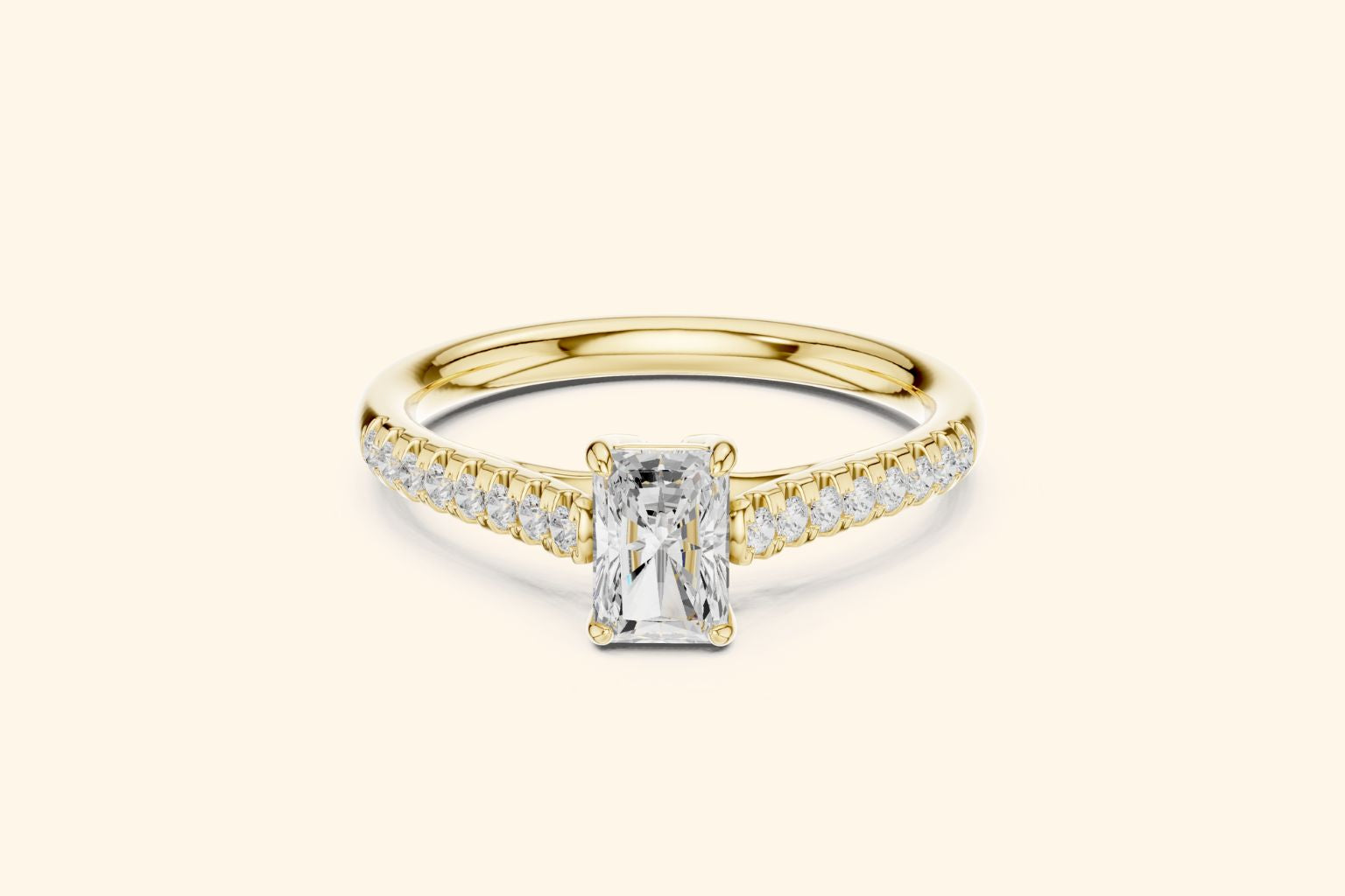 ellow gold diamond engagement ring with a horizontal radiant-cut center stone and diamonds set along the band.
