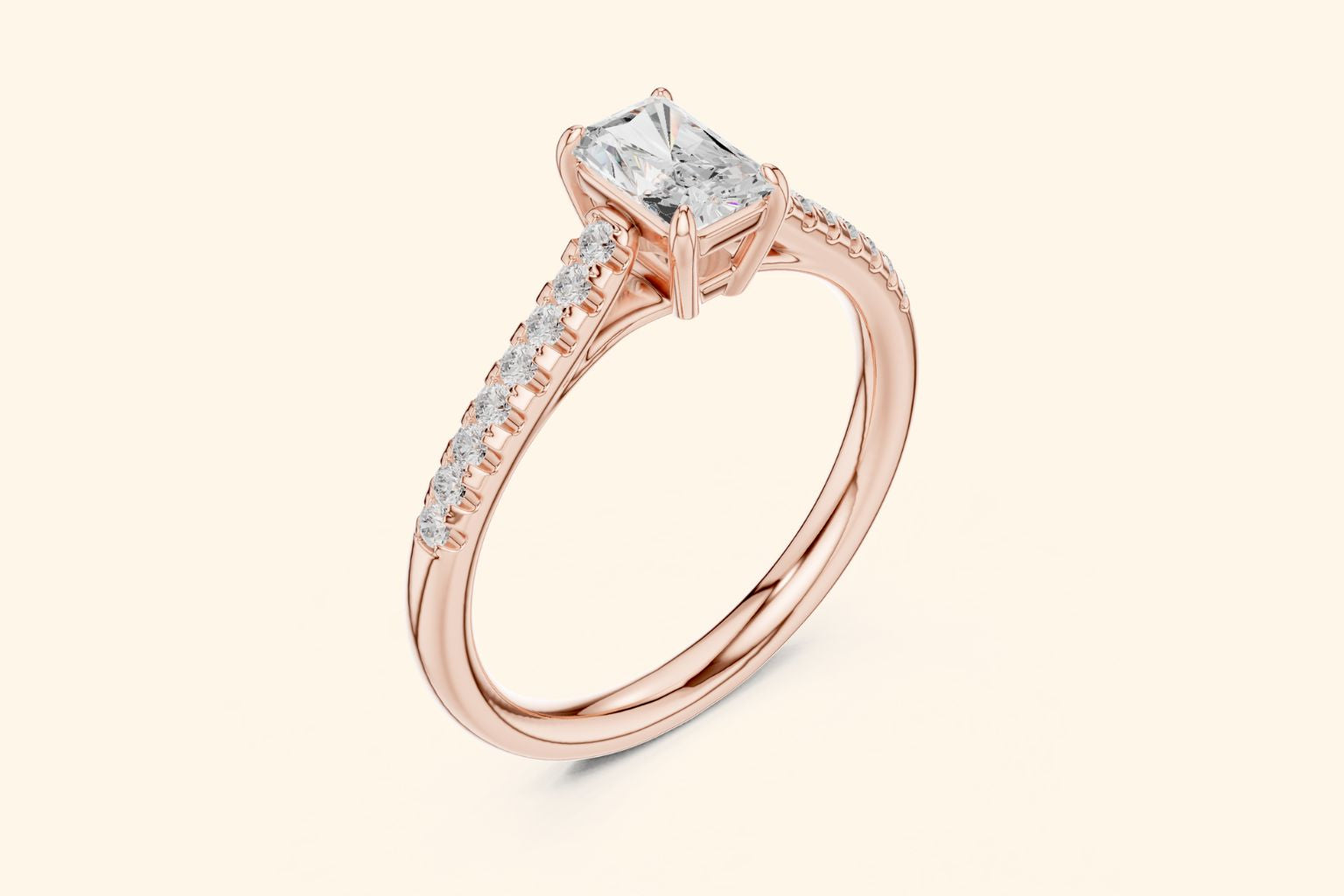 Side view of a rose gold solitaire ring, showing the elevated setting of the radiant-cut diamond and the row of accent diamonds on the band.