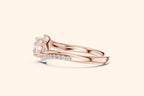 Elegant rose gold engagement ring with round diamond and ribbon-style setting 3