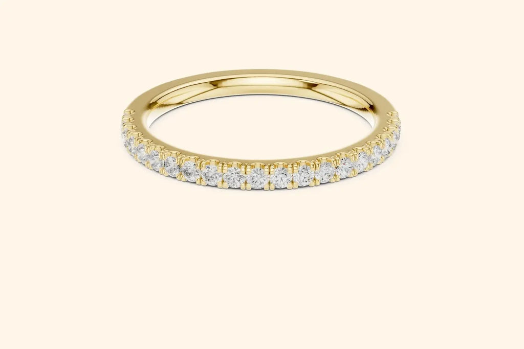 Real gold ring with round-cut diamonds in a polished, elegant band design.