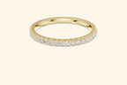 Real gold ring with round-cut diamonds in a polished, elegant band design.