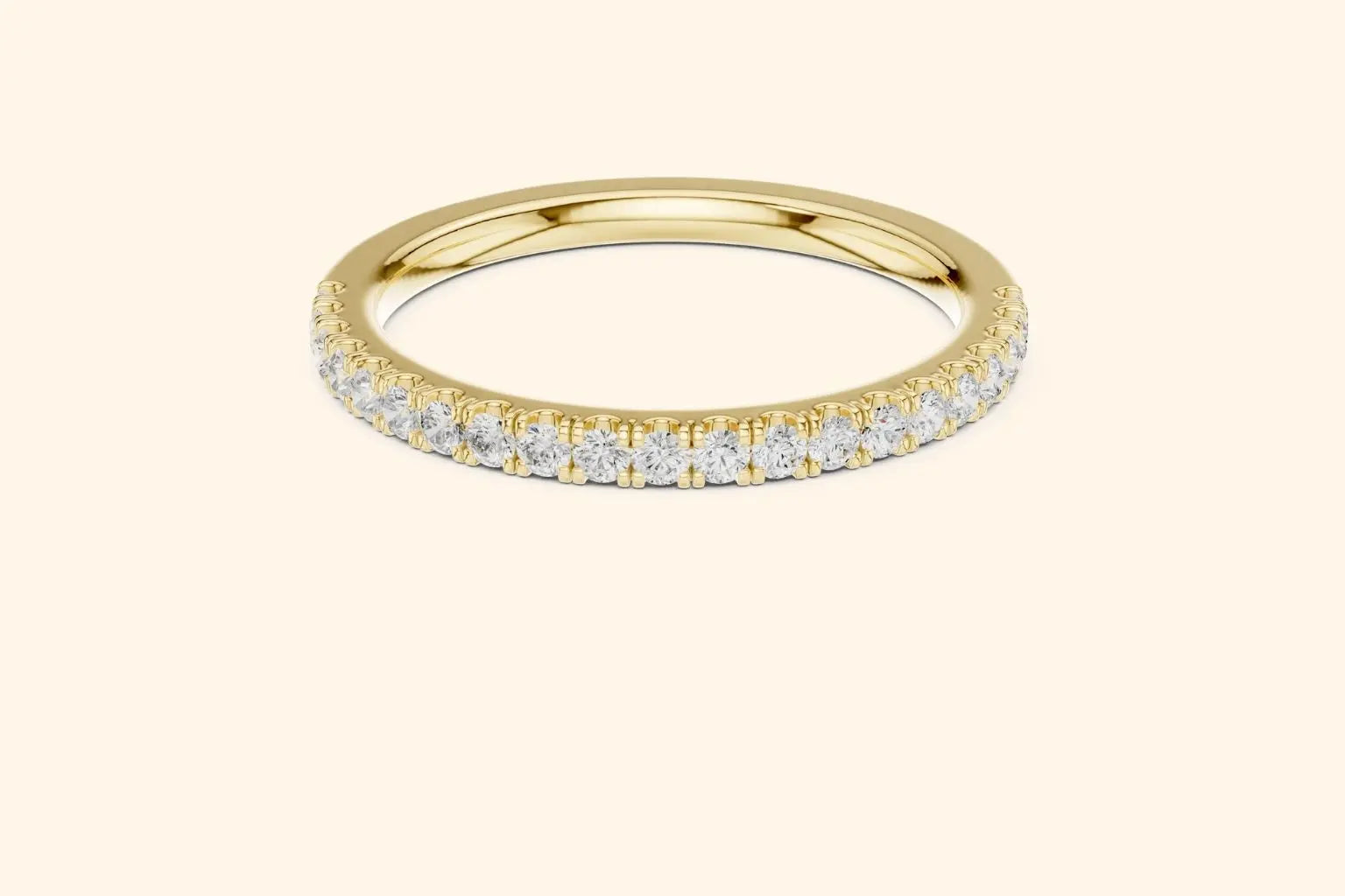 Real gold ring with round-cut diamonds in a polished, elegant band design.