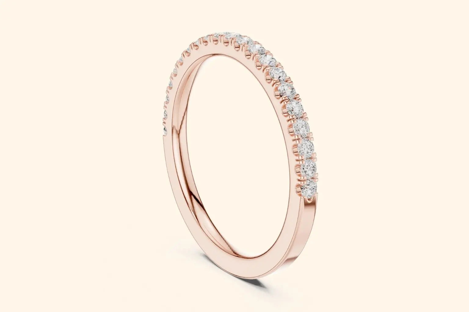 Rose gold ring with round-cut diamonds in a polished, elegant band design. 1