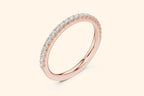 Rose gold ring with round-cut diamonds in a polished, elegant band design. 2