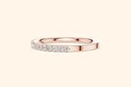 Rose gold ring with round-cut diamonds in a polished, elegant band design. 3