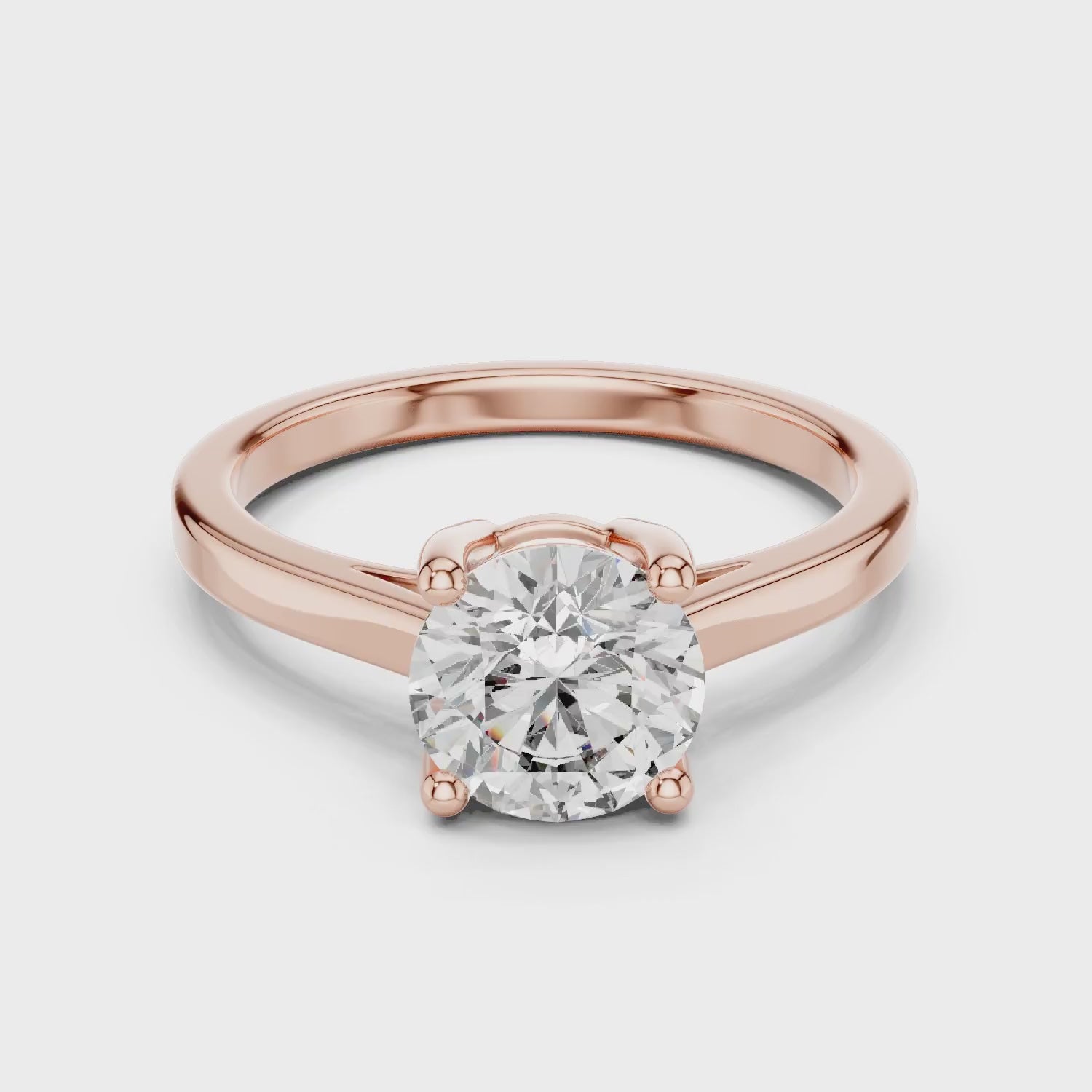 Elegant rose gold engagement ring with round-cut diamond and pavé split shank for a timeless bridal look.