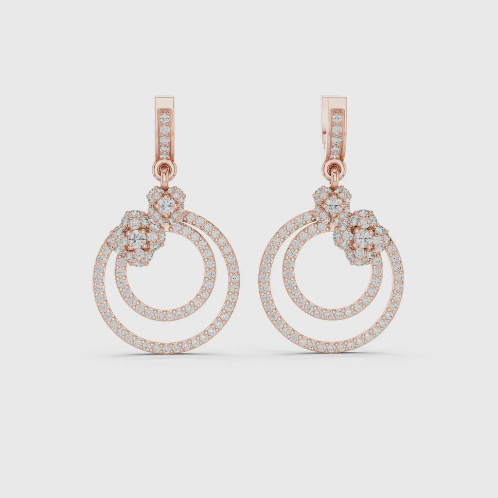 A pair of rose gold drop earrings featuring
