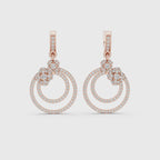 A pair of rose gold drop earrings featuring