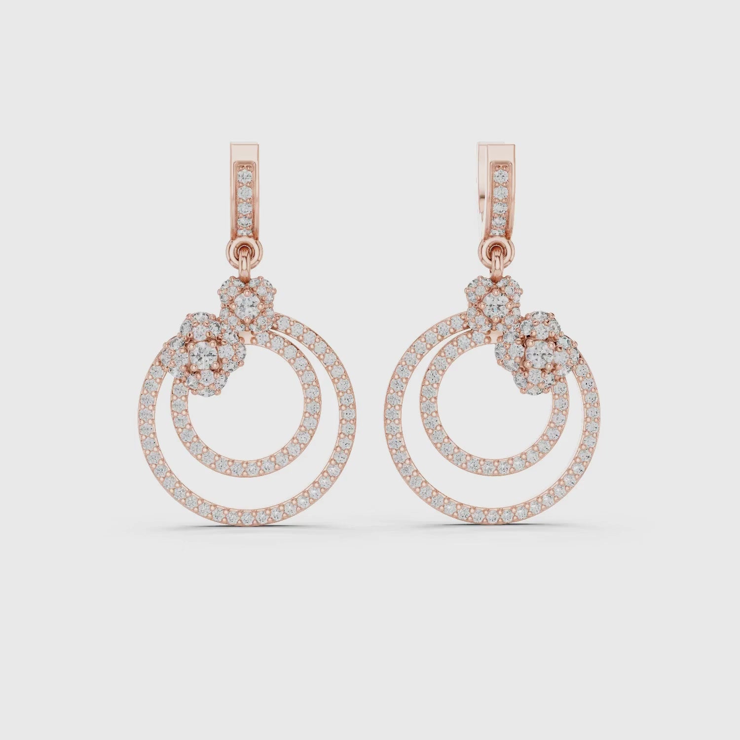A pair of rose gold drop earrings featuring
