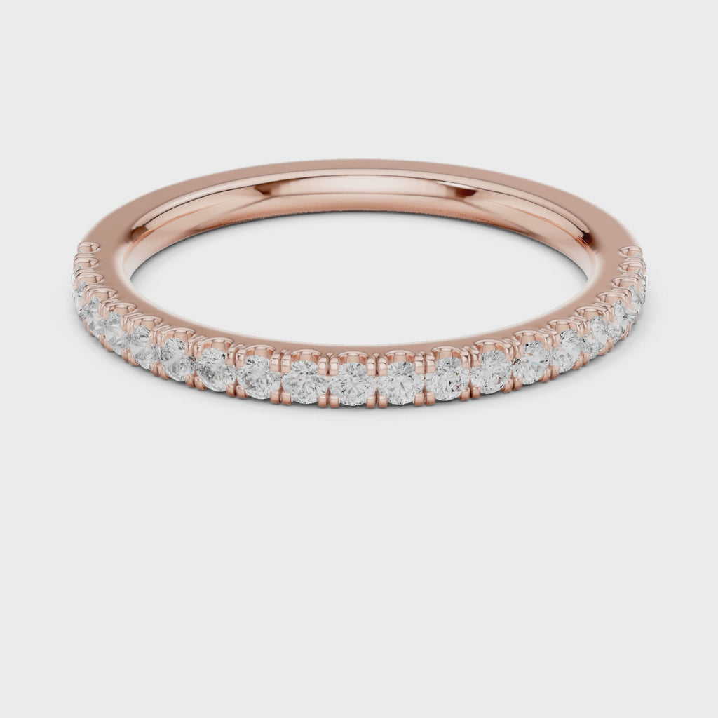 Rose gold ring with round-cut diamonds in a polished, elegant band design.