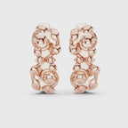 A pair of huggie earrings featuring a detailed
