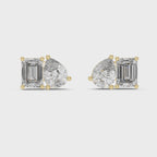 Pair of yellow gold stud earrings featuring a cluster of one pear-cut and one emerald-cut diamond