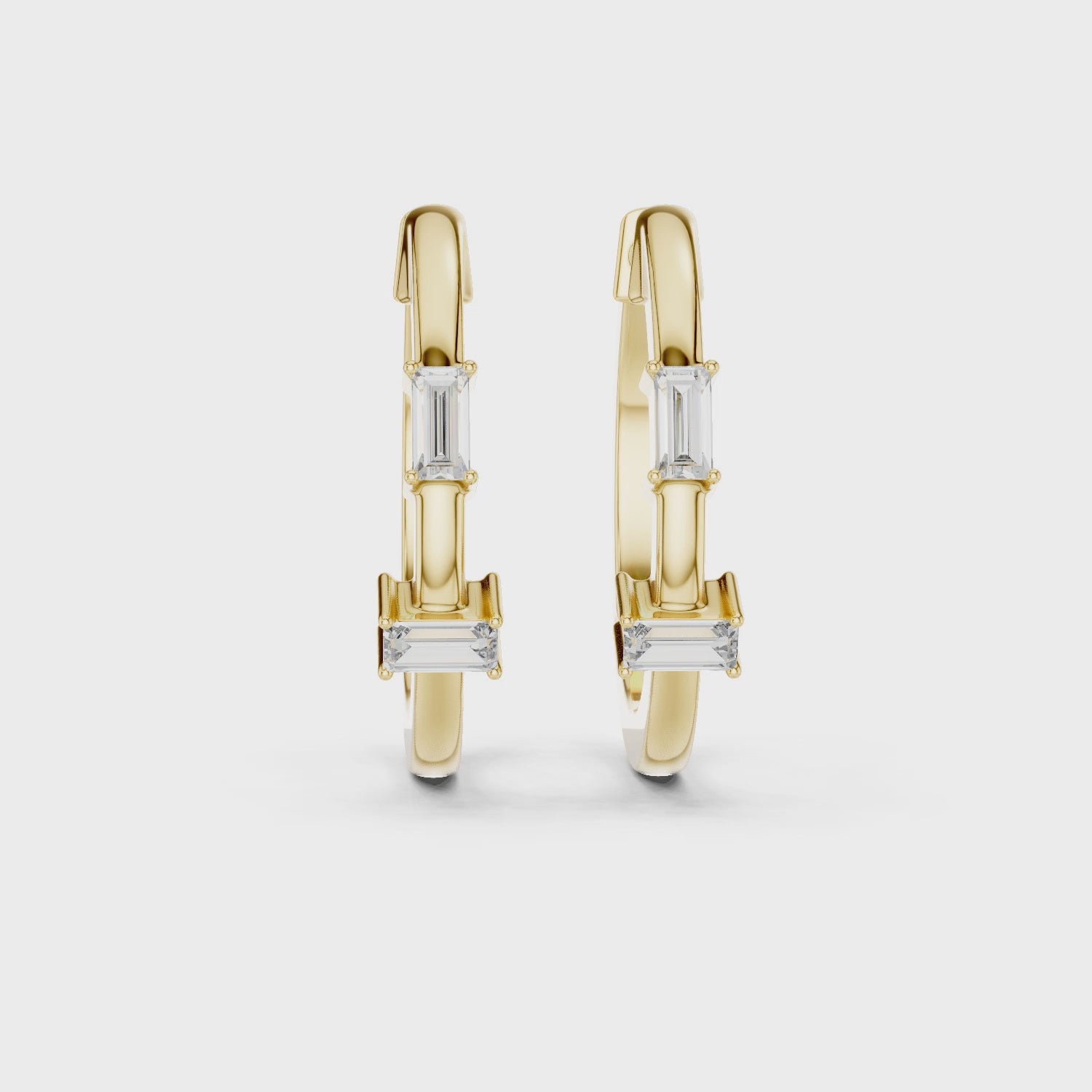 Pair of yellow gold hoop earrings with bar-set baguette diamonds and round diamond accents in a modern geometric design