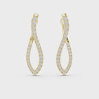 Pair of yellow gold twisted infinity hoop earrings with pave-set diamonds on a white background